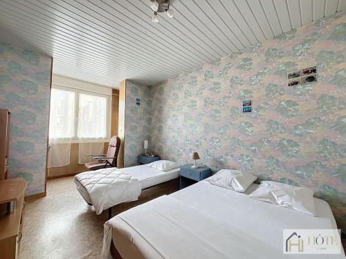 Un pat sau paturi într-o cameră la L'Atelier des Sables - Appartement Plage à 50m