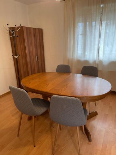 a wooden table and chairs in a room at Düsseldorf 1995 in Düsseldorf