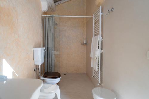 a bathroom with a toilet and a sink and a shower at Palazzo Muci in Nardò