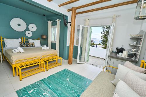 a bedroom with a bed and a blue wall at Bellissimo Resort in Agios Ioannis Mykonos
