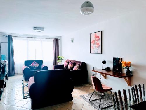 a living room with two couches and a table at Milimani apartments10 in Nakuru
