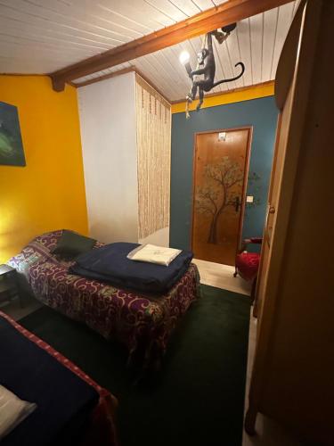 a small room with a bed and a door at LA Dryade 6 in Monnet-la-Ville