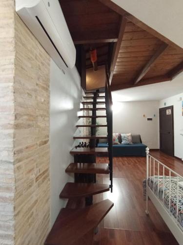 a staircase in a house with a blue couch at Casa Paradiso in Chieti