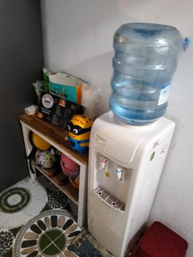 a bottle of water on top of a refrigerator at BONNIE HOMESTAY Mui Ne in Mui Ne