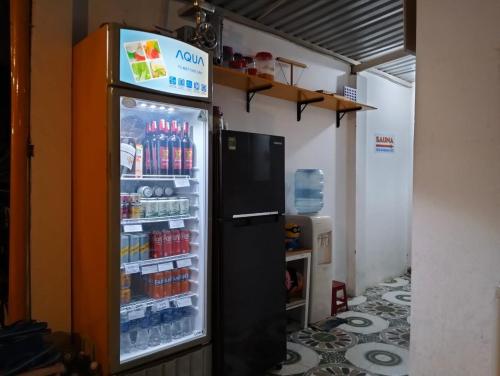 a refrigerator filled with lots of drinks in a room at BONNIE HOMESTAY Mui Ne in Mui Ne