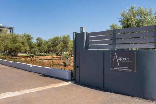 a gate to a park with a sign on it at Aspect Luxury Apartments with Pool in Galangádhos