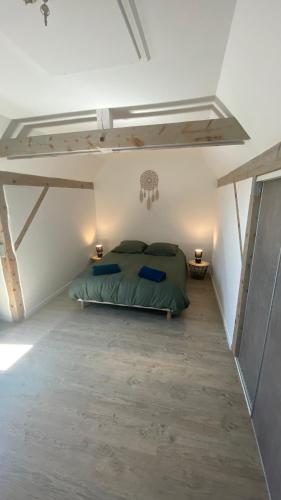 - une chambre blanche avec un lit vert dans l'établissement Ô Ciel d'Obernai, à Obernai