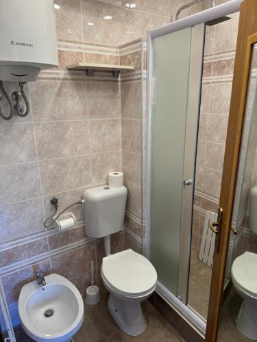 a small bathroom with a toilet and a sink at Studio Lorena in Mali Lošinj
