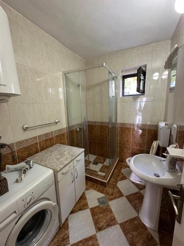 a bathroom with a washing machine and a sink at Bosko in Kotor