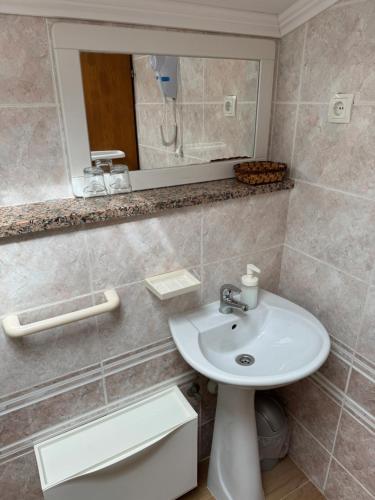 a bathroom with a sink and a mirror at Studio Lorena in Mali Lošinj