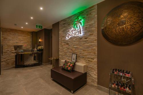 a bar with a sign on a brick wall at Hartnoll Hotel & Spa in Tiverton