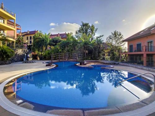 a large pool with blue water in a courtyard at Sunscape T2 in Funchal