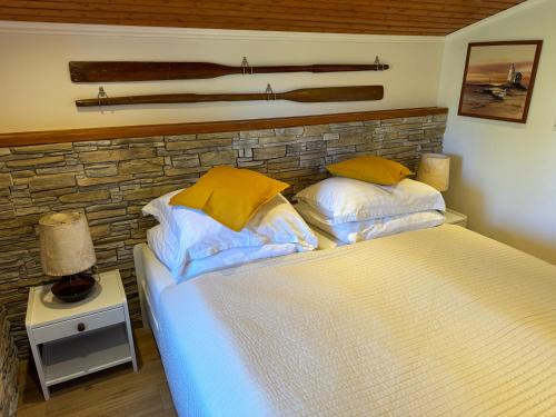 a bedroom with a large bed with yellow pillows at Studio Lorena in Mali Lošinj