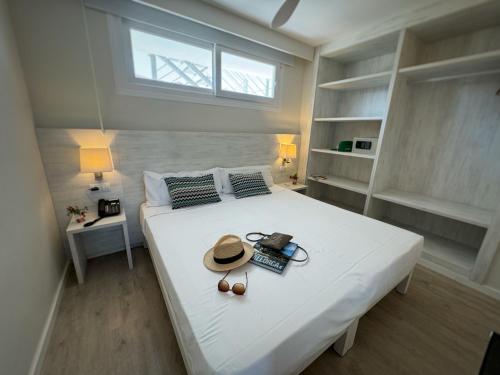 a bedroom with a large white bed with a hat on it at INN Mallorca Aparthotel in Magaluf