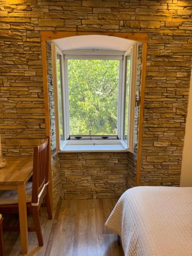 a bedroom with a window and a table and a bed at Studio Lorena in Mali Lošinj
