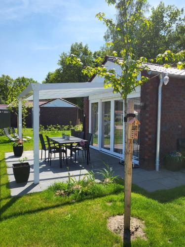 a pavilion with a table and chairs on a patio at Elseblick in Schüttorf