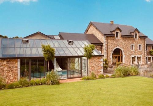 a large brick house with a large yard at Thermes Oppidum in Theux
