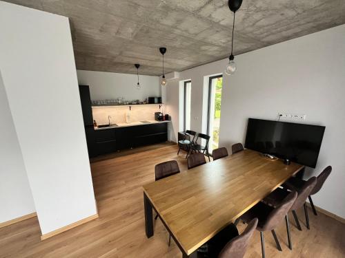 a dining room with a large wooden table and chairs at Jamy House in Habovka