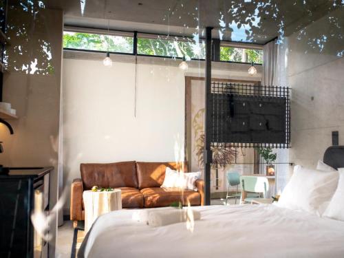 a bedroom with a bed and a couch at Brooklyn Blok in Pretoria