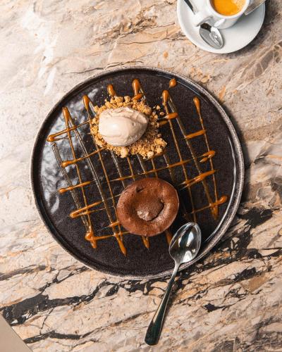 a plate with a donut on a table with at Soko Hotels-Pont du Gard in Remoulins