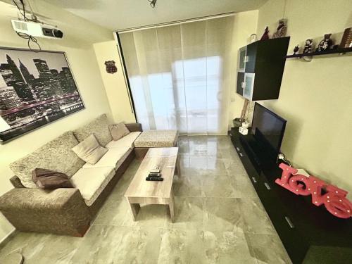 a living room with a couch and a coffee table at Lo Gambussi Deltebre in Deltebre