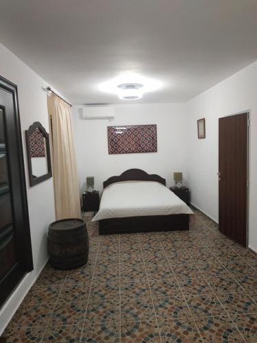 a bedroom with a bed and a rug at Къщата с разкопките - The house with the excavations in Sozopol