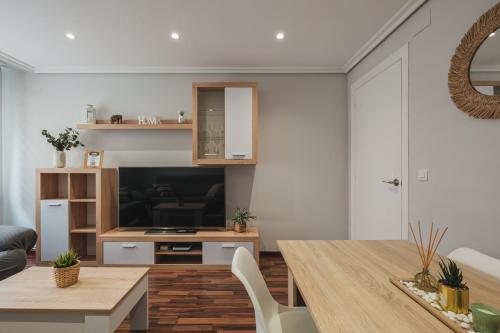 a living room with a table and a television at Apartamento EL RINCON LOGROÑES in Logroño