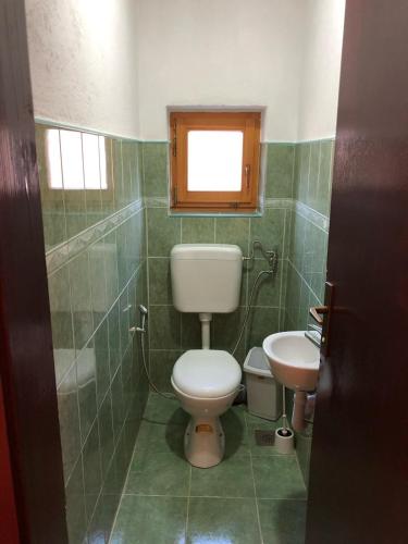 a bathroom with a toilet and a sink at Vila Sunsets in Konjic