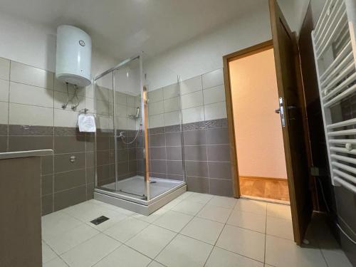 a shower with a glass door in a bathroom at Vila Sunsets in Konjic