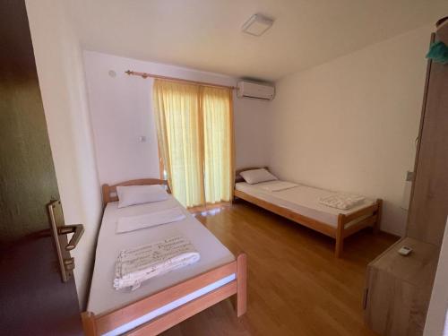 a small room with two beds and a window at Vila Sunsets in Konjic