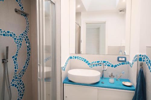 a bathroom with a sink and a mirror at Casa Vento di Mare in Ischia