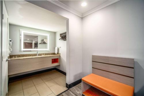 a bathroom with a sink and a mirror at Travelodge Inn & Suites by Wyndham Bell Los Angeles Area in Bell