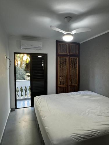a bedroom with a bed and a ceiling fan at LINDO APTO ITAGUA (UBATUBA) in Ubatuba