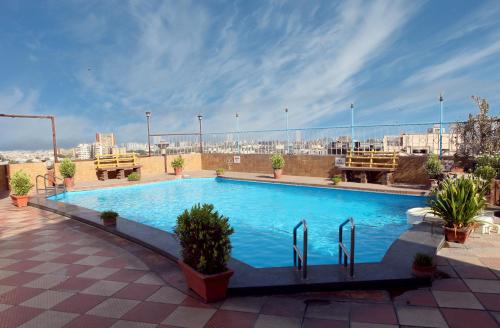a large blue swimming pool on top of a building at Lords Plaza Surat in Surat