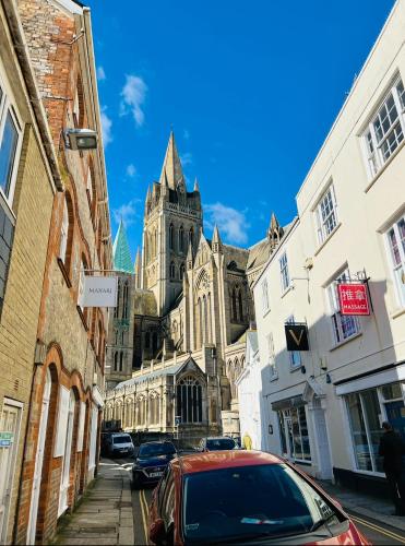 a car parked on a street in front of a cathedral at Private Double Room with Ensuite, No Breakfast, Truro City Centre in Truro