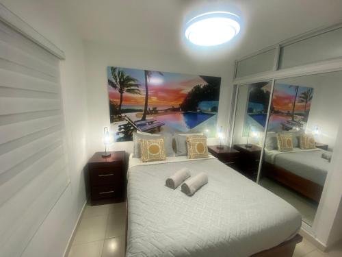 Schlafzimmer mit einem Bett mit Wandgemälde in der Unterkunft Residencial Maite Vl in Santiago de los Caballeros