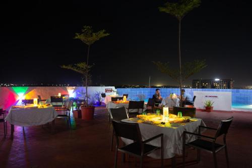 a group of tables and chairs with lights at night at Gokulam Park Coimbatore in Coimbatore