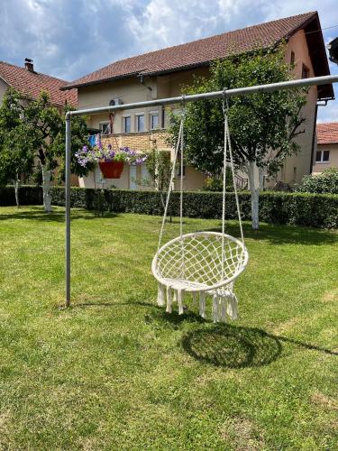 a swing in a yard with a house at Apartment Ramdedovic1 in Sarajevo
