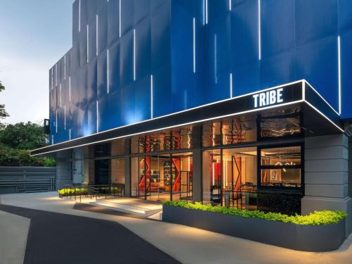 a large building with a blue facade at TRIBE Living Bangkok Sukhumvit 39 by AccorHotels in Bangkok