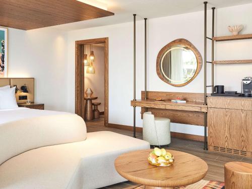 a hotel room with a bed and a mirror at Hyde Bodrum - Adult Only in Bodrum City