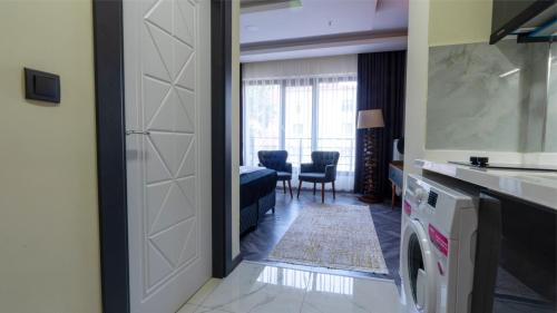a room with a door leading to a living room at ELEGANCE SİRİUS in Kayseri