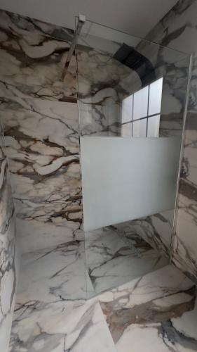 a marble wall with a whiteboard in a room at Hôtel Séjour D'Ardenne in Spa