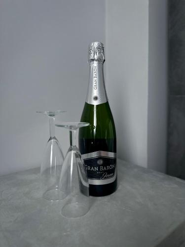 a bottle of wine sitting on a table with two glasses at Hôtel Séjour D'Ardenne in Spa