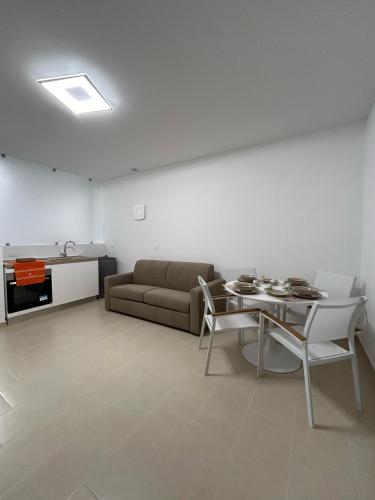 a living room with a couch and a table at Little Rose in Catania