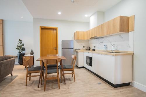 a kitchen and dining room with a table and chairs at Loft Hotel Apartment in Addis Ababa