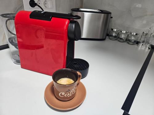 a coffee maker on a counter with a cup of coffee at Hedonica 2 New Apartment in Vrdnik