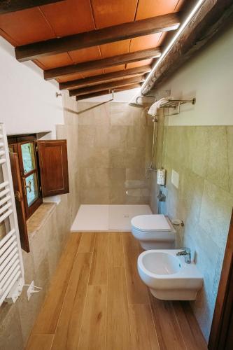 a bathroom with two toilets and a sink at Borgo Il Poggiaccio Residenza d'Epoca in Sovicille