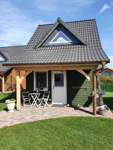 a pavilion with a table and chairs on a patio at TinyHausDorf Wendland in Gartow