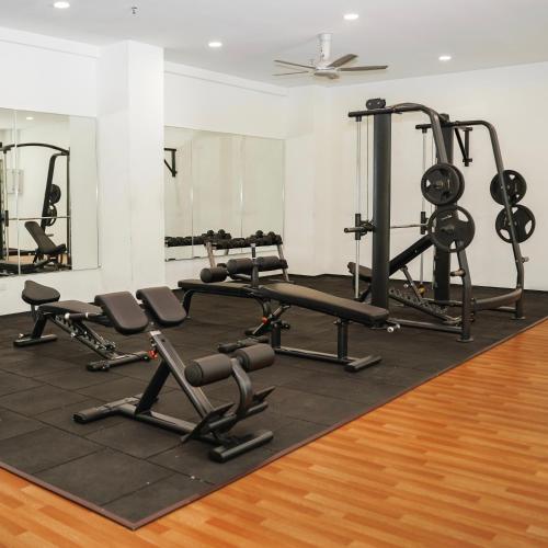 a gym with several treadmills and weights at KLIA AIRPORT HOMESTAY 2 in Sepang