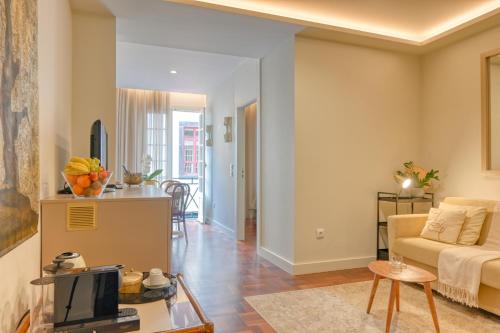 a living room with a couch and a table at Colombo Square, a Home in Madeira in Funchal
